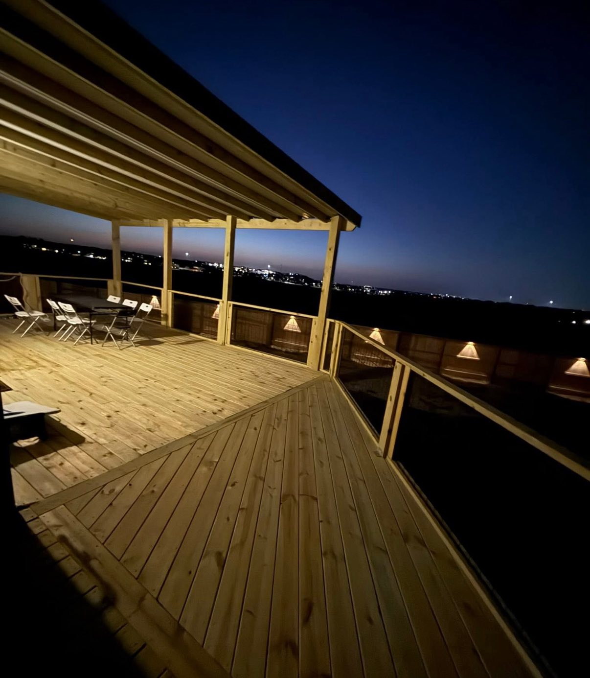 Backyard deck with built-in lighting at sunset