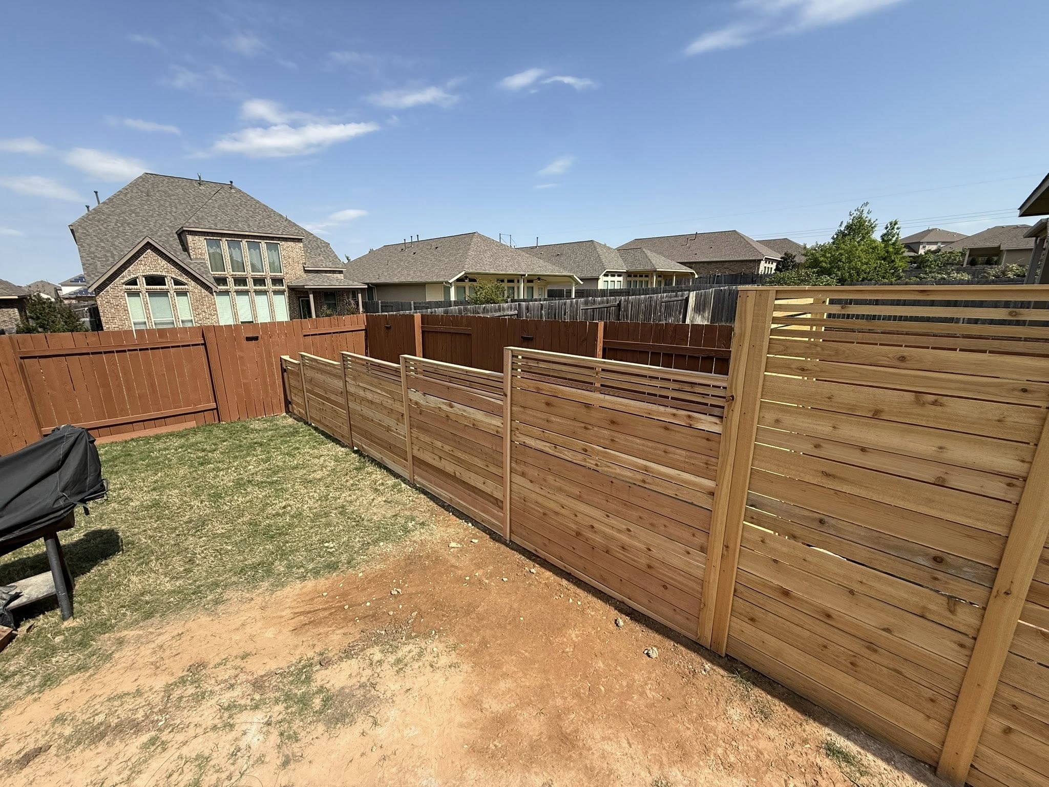 Modern horizontal cedar fence with metal accent panels