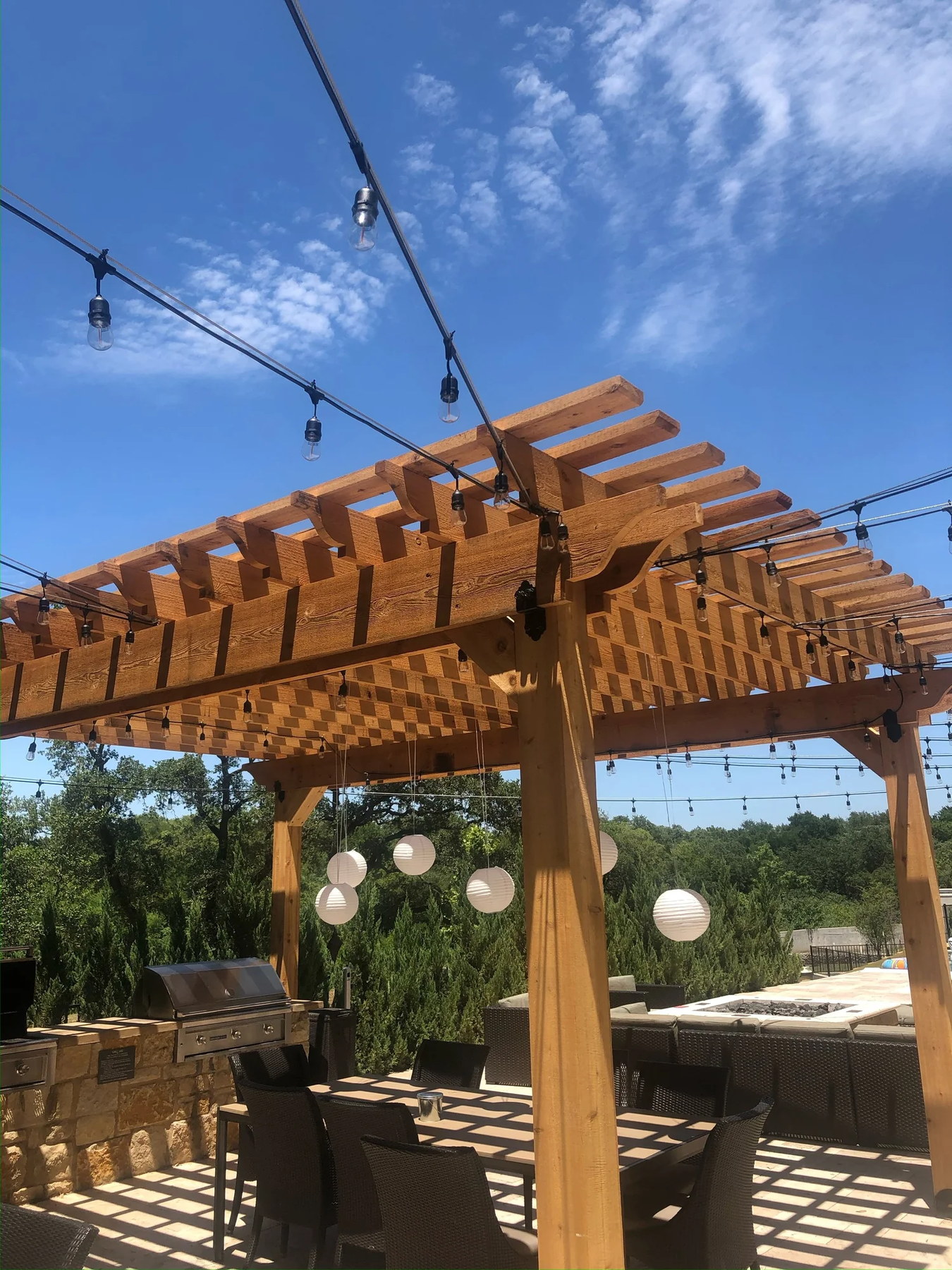 Cedar pergola with string lights, Hill Country view