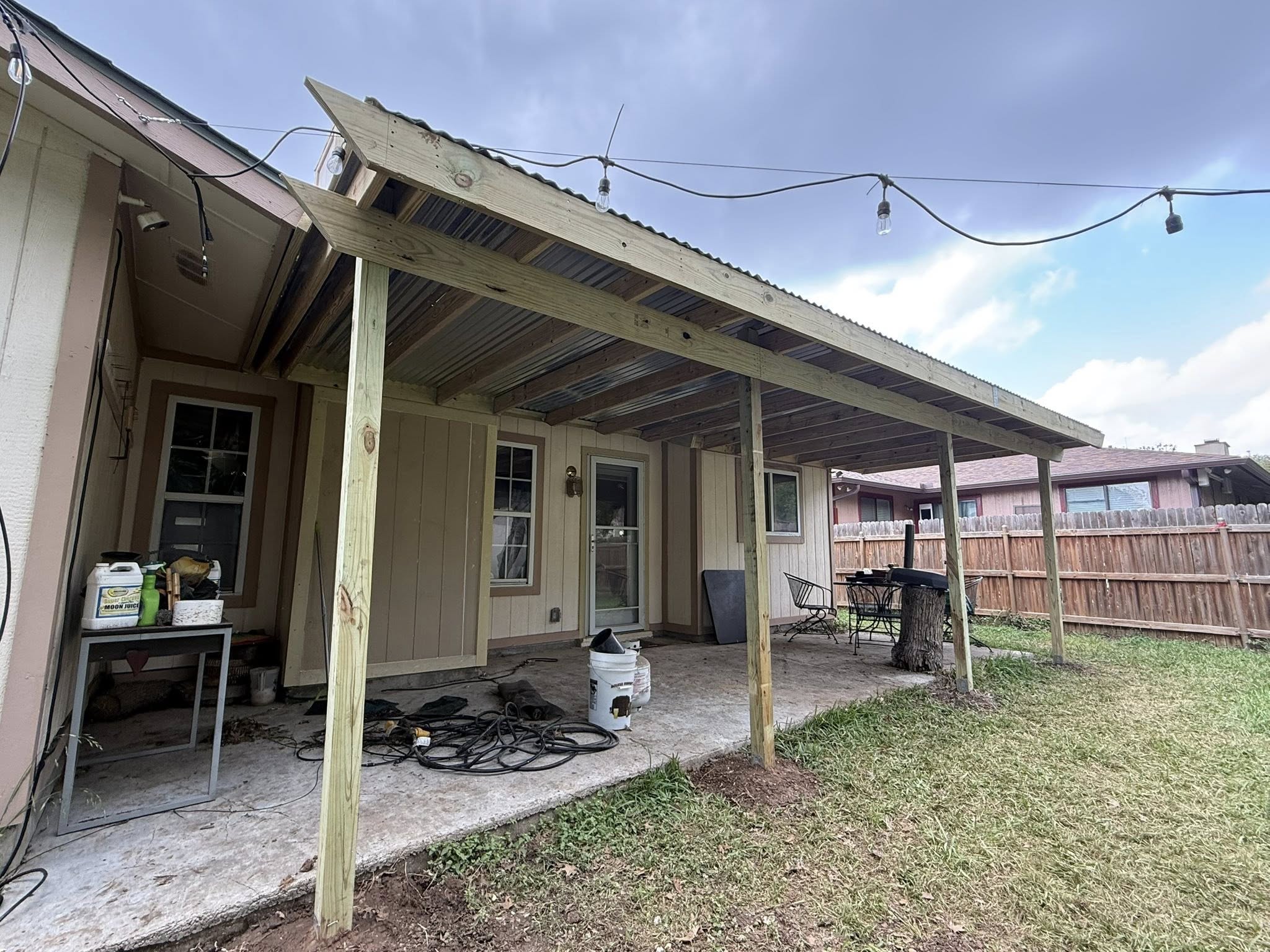 Lean-to patio cover with corrugated metal roof