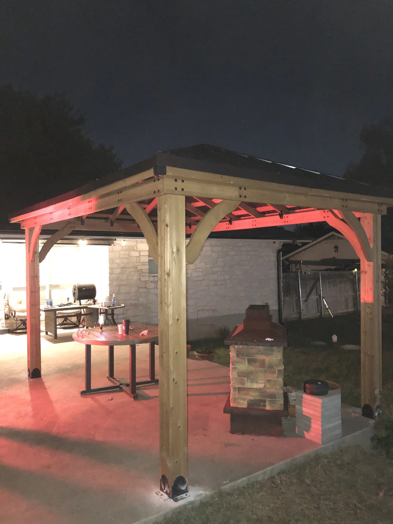 Covered pavilion with stone fireplace at night