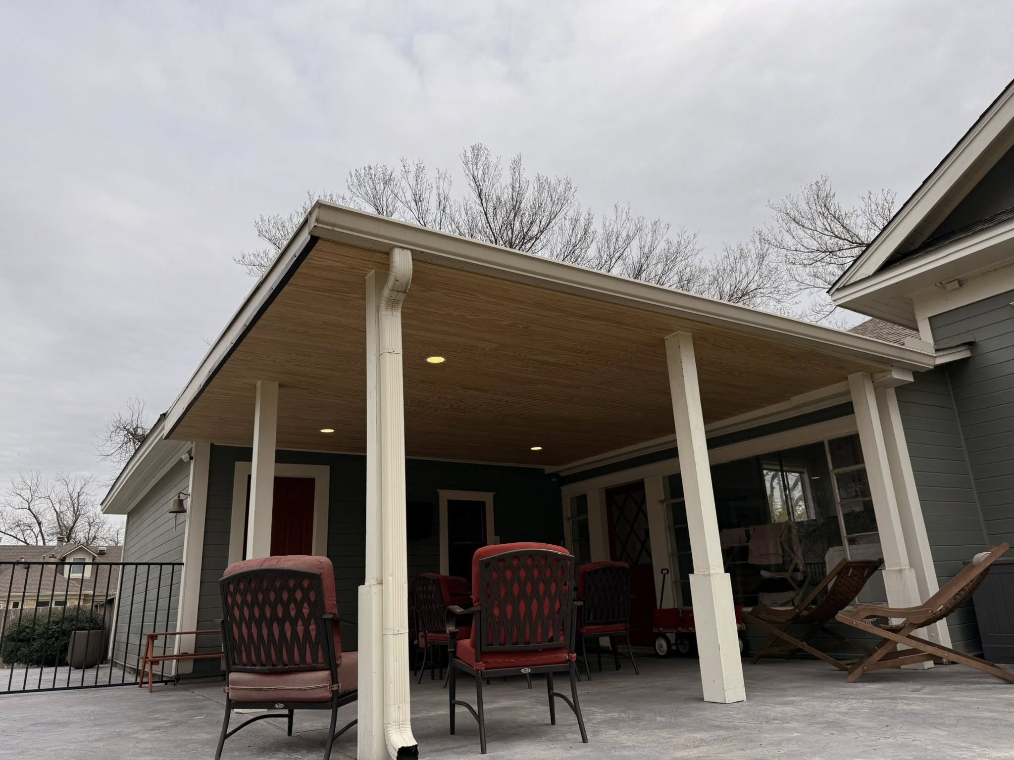 Patio cover with wood ceiling and white columns