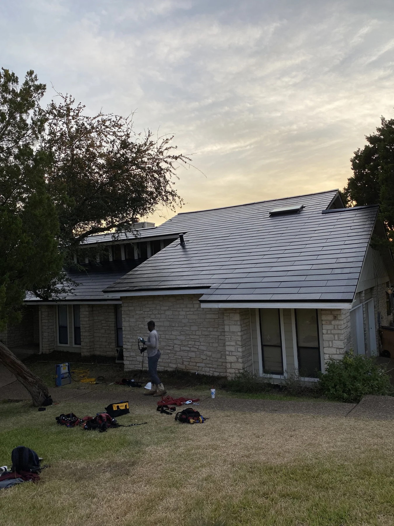 A finished roof replacement by JB Contracting at golden hour.