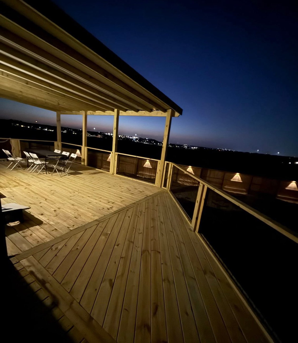 Custom backyard deck in Austin at sunset with built-in lighting