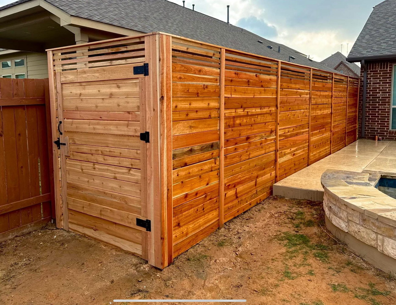 Stained horizontal cedar fence on an Austin home