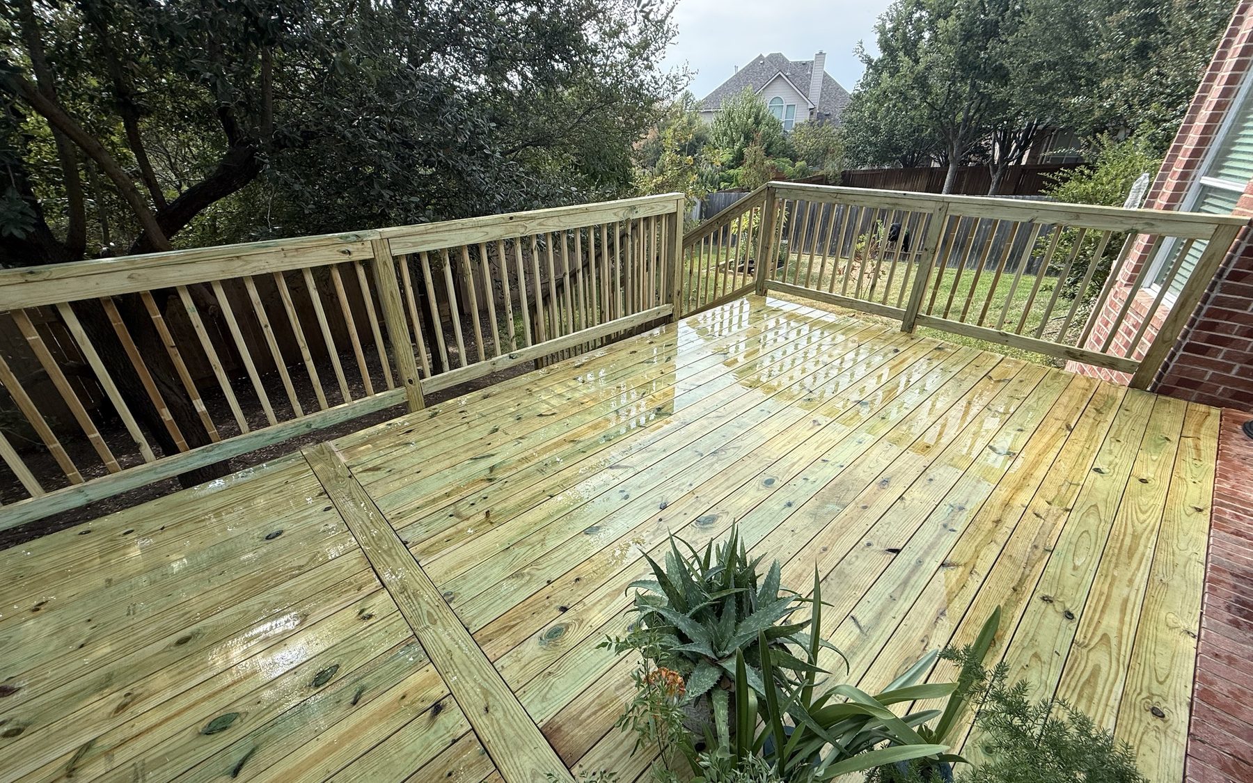 Custom pressure-treated deck with picket railing built by JB Contracting ATX in Austin, TX