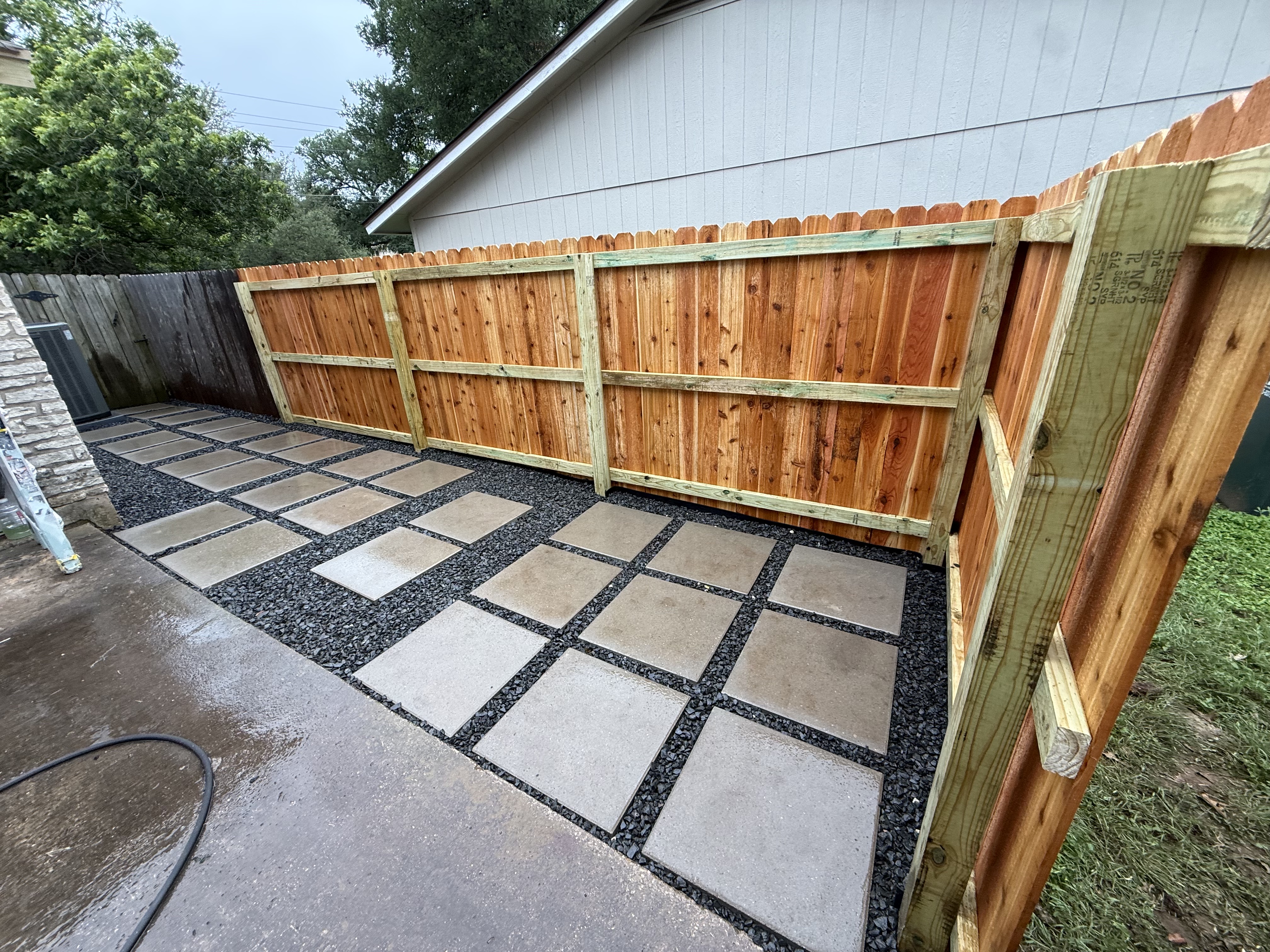 Cedar privacy fence with paver patio hardscape, Austin TX