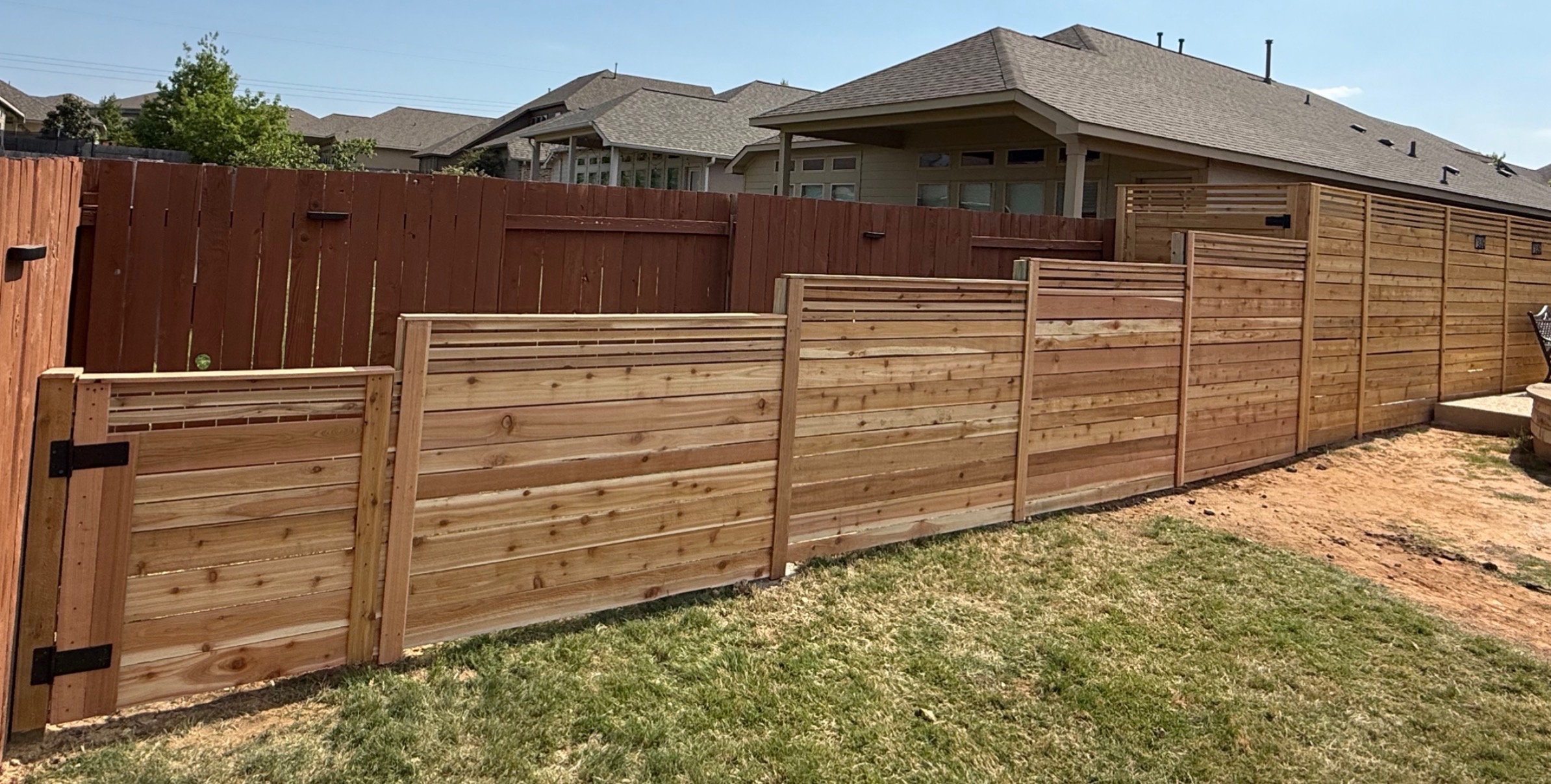 Cedar privacy fence build for a Kyle, TX home at golden hour.