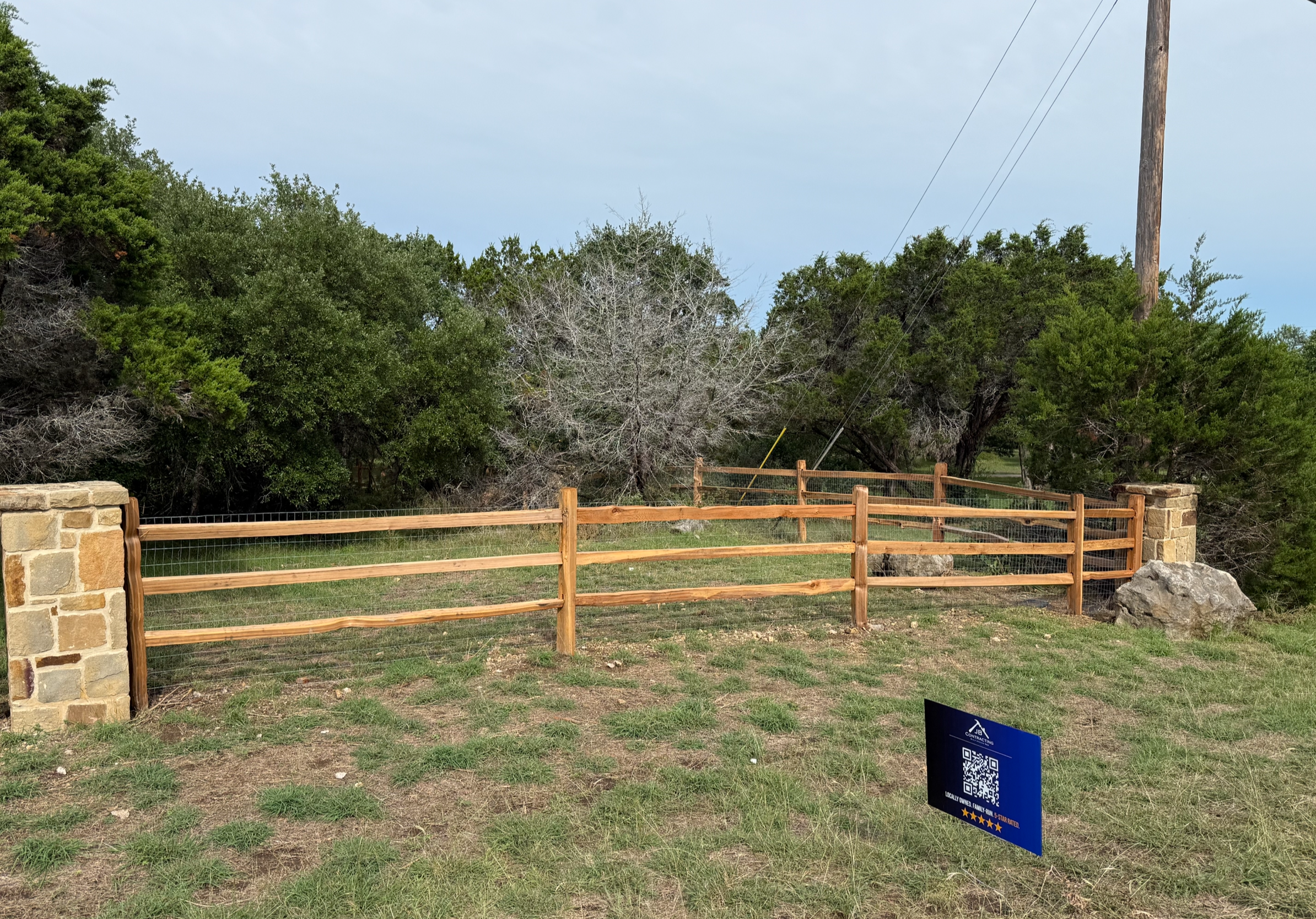 Hill Country split-rail fence with stone post pillars, Dripping Springs TX