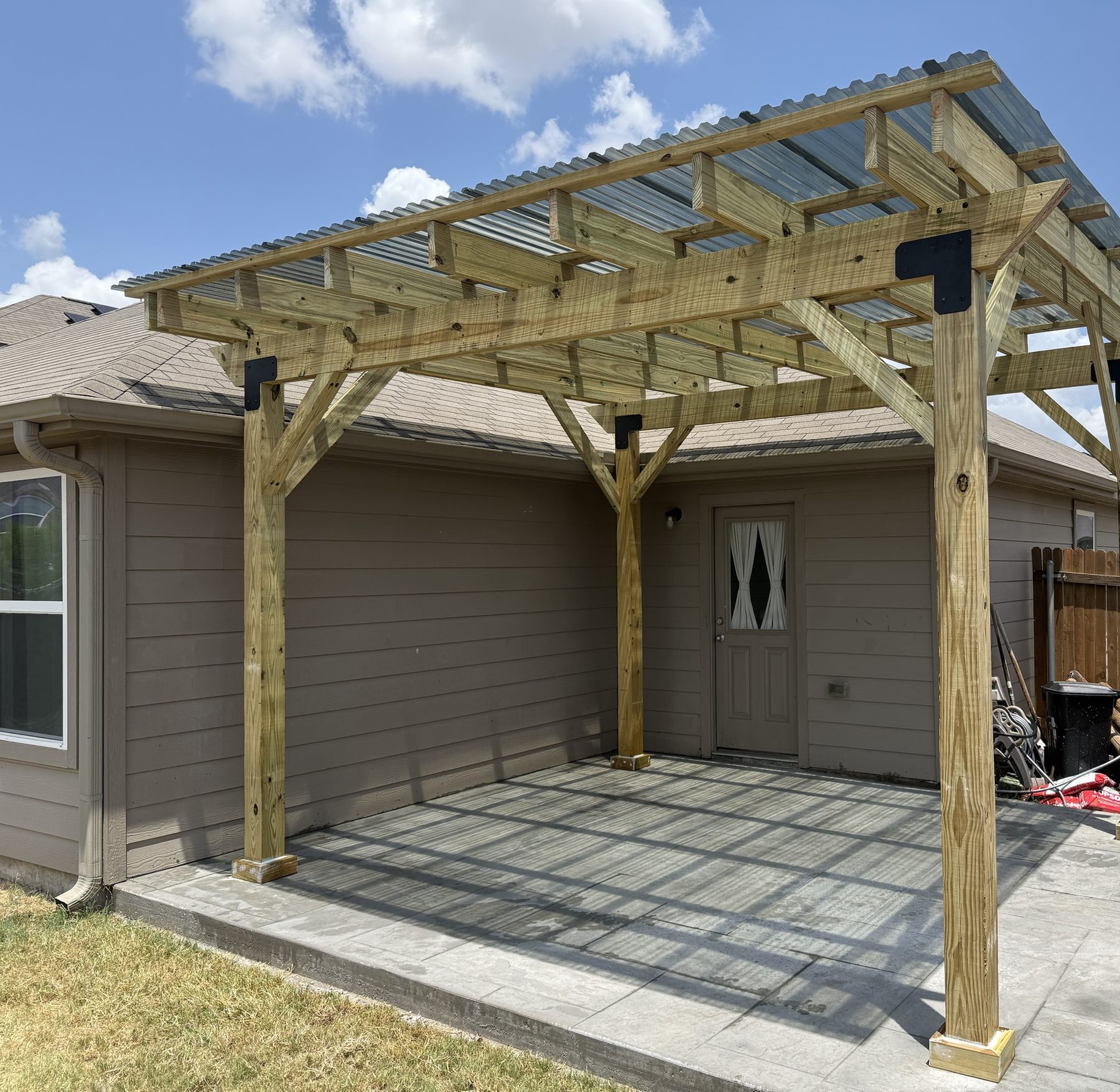 Attached patio cover with polycarbonate roof built for a Cedar Park, TX home