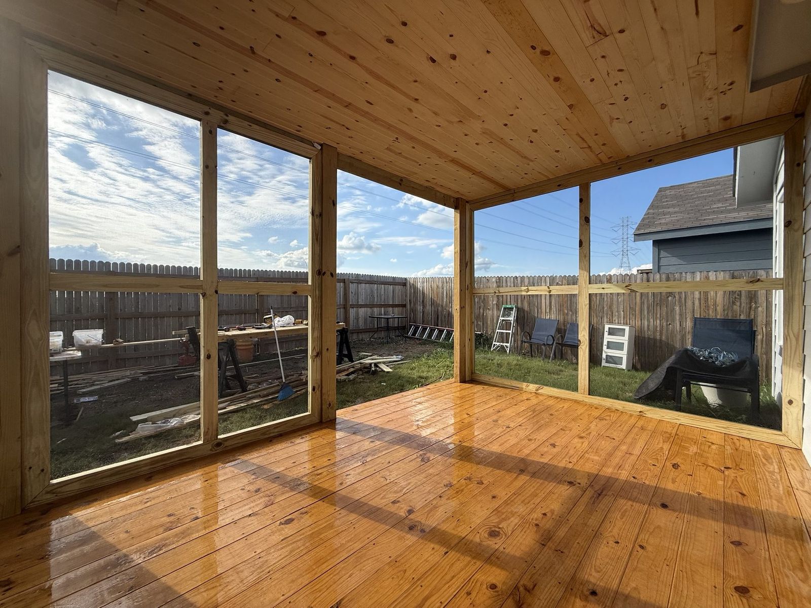 Corner view of a screened porch build showing the pine ceiling and framed screen openings, Austin TX